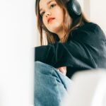 a woman sitting in a chair with headphones on
