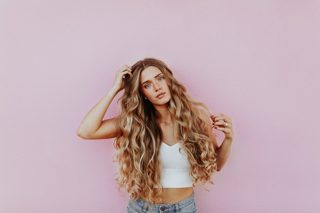 Conclusion by Endless Relaxation woman standing next to pink wall while scratching her head